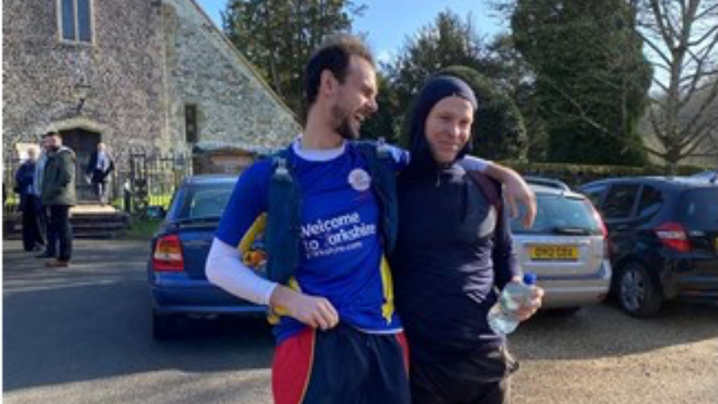 Two men smiling after fundraising ultra marathon