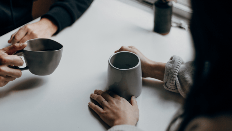 Two people drinking coffee