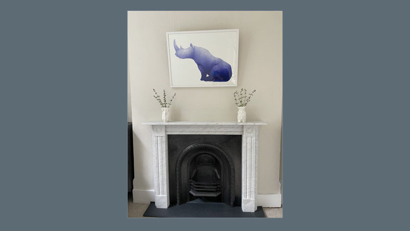 Blue rhino artwork over fireplace