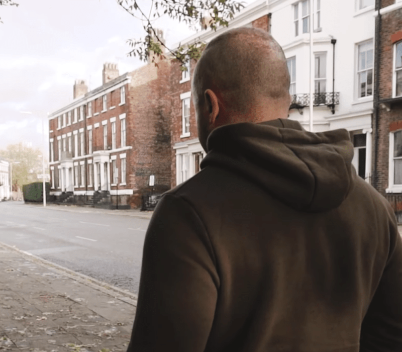 Man walking up Catharine Street Liverpool.