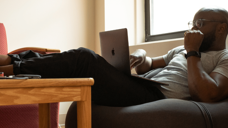 Man on beanbag on laptop