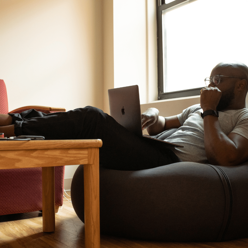 Man on beanbag on laptop