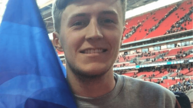 Man at football match holding flag