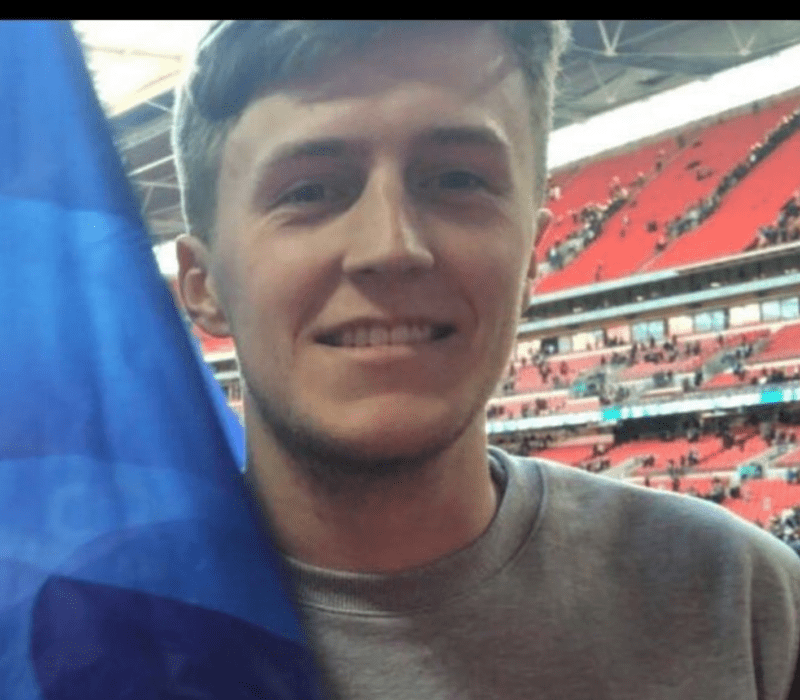 Man at football match holding flag