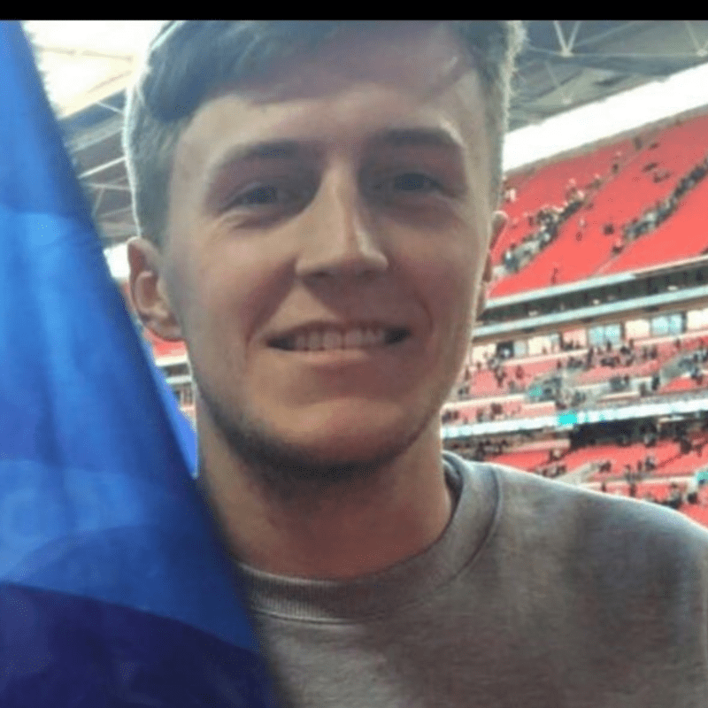 Man at football match holding flag