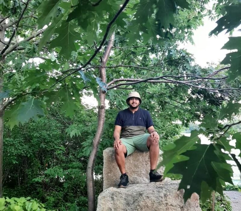 Man sitting on rocks in a forest