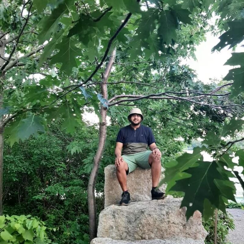 Man sitting on rocks in a forest