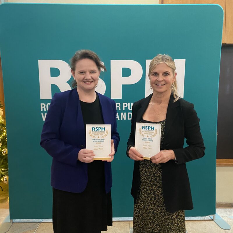 Two women holding award