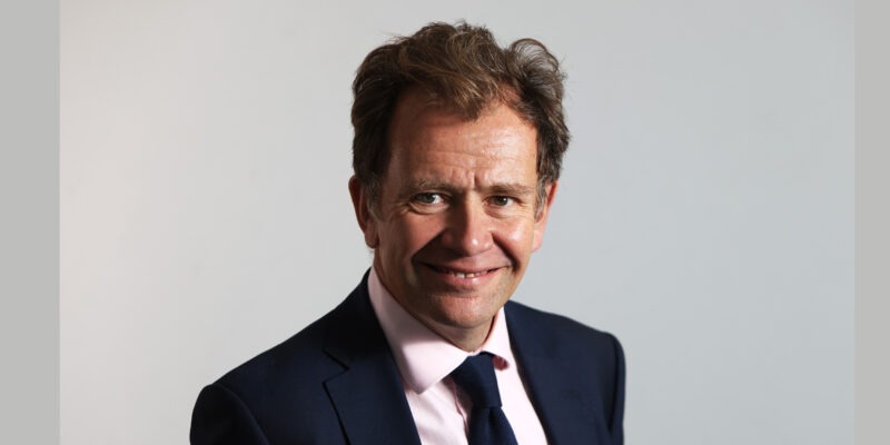 Man in suit smiling at camera