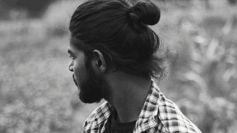 Man in profile in field and check shirt