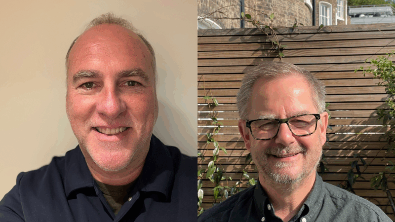 Two men smiling at camera