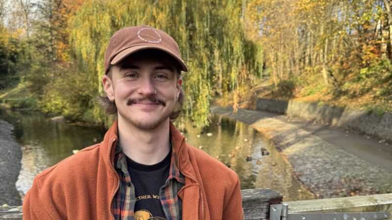 Man in cap smiling at camera