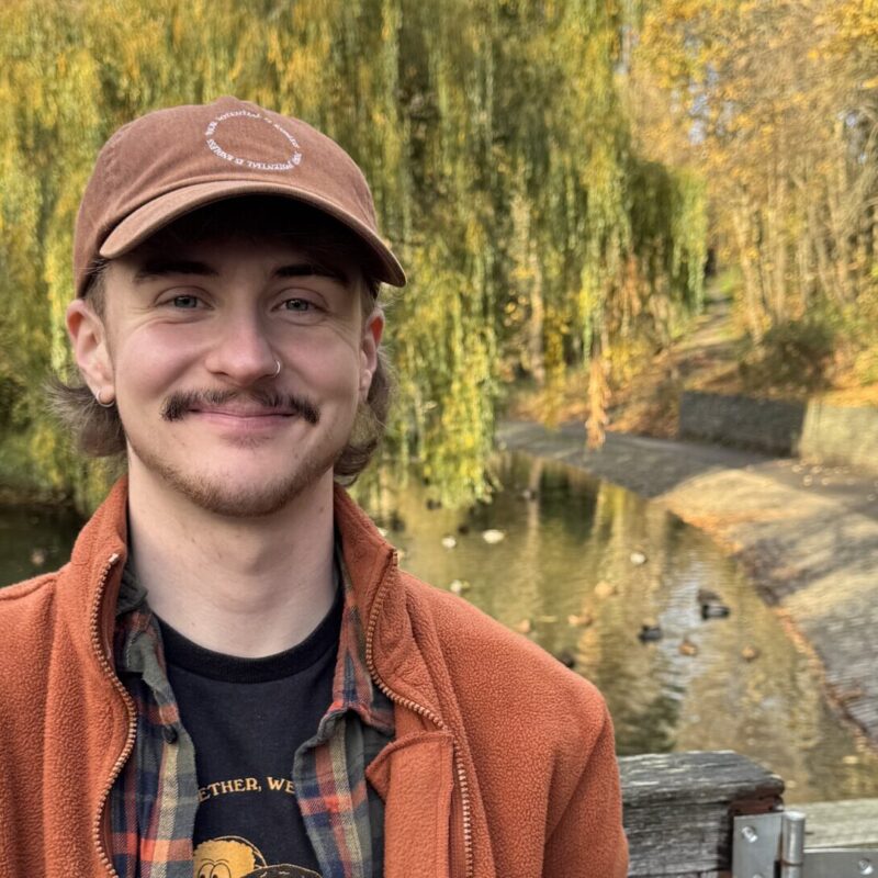 Man in cap smiling at camera