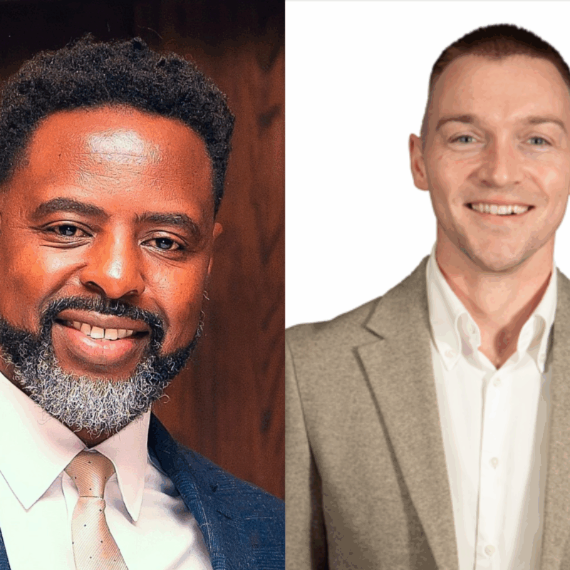 Two men smiling at camera