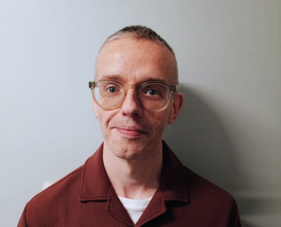 Man with glasses looking at camera