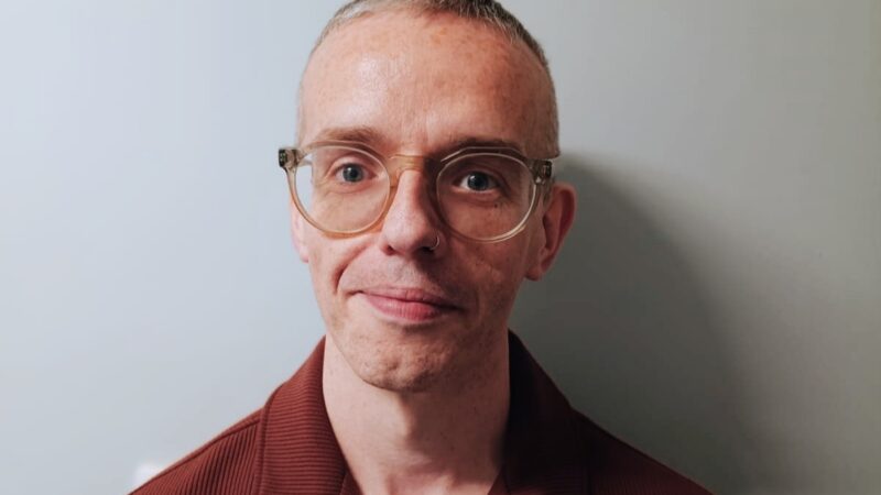 Man with glasses looking at camera