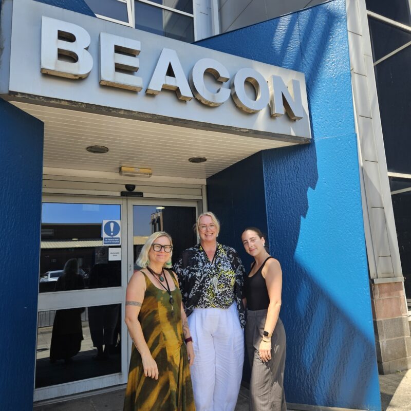 Three women outside building